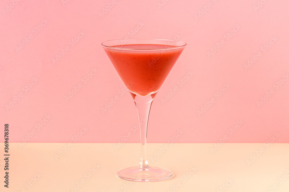 Strawberry smoothie cup on a pink and yellow background Strawberry smoothie cup on a pink and yellow background