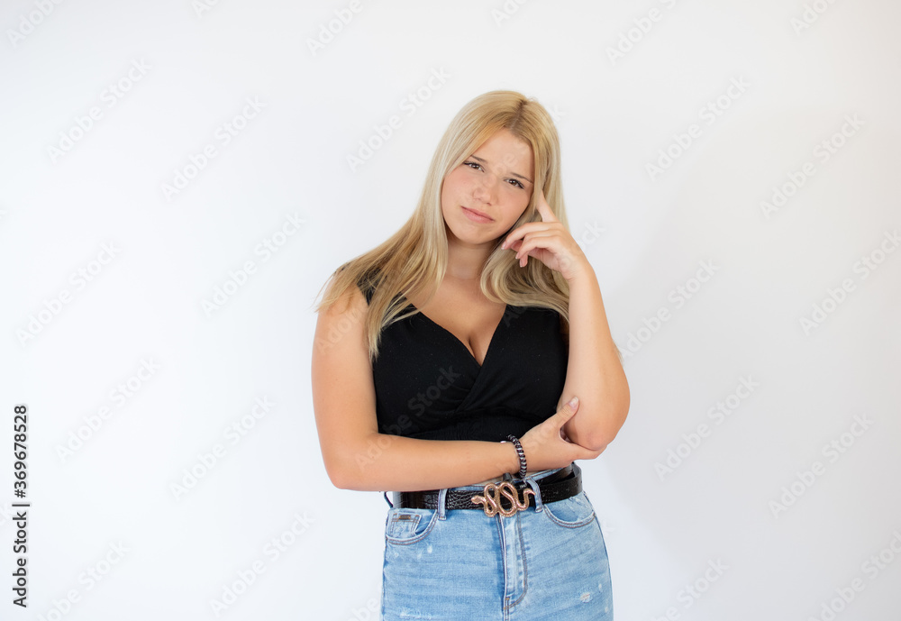 Beautiful blonde girl in black shirt with thoughtful gesture Beautiful blonde girl in black shirt with thoughtful gesture