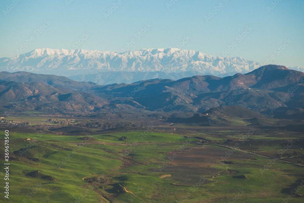 areal view of rolling hills on a hot air balloon in Temecula southern California early morning ride sunrise snow cap mountains stock photo royalty free