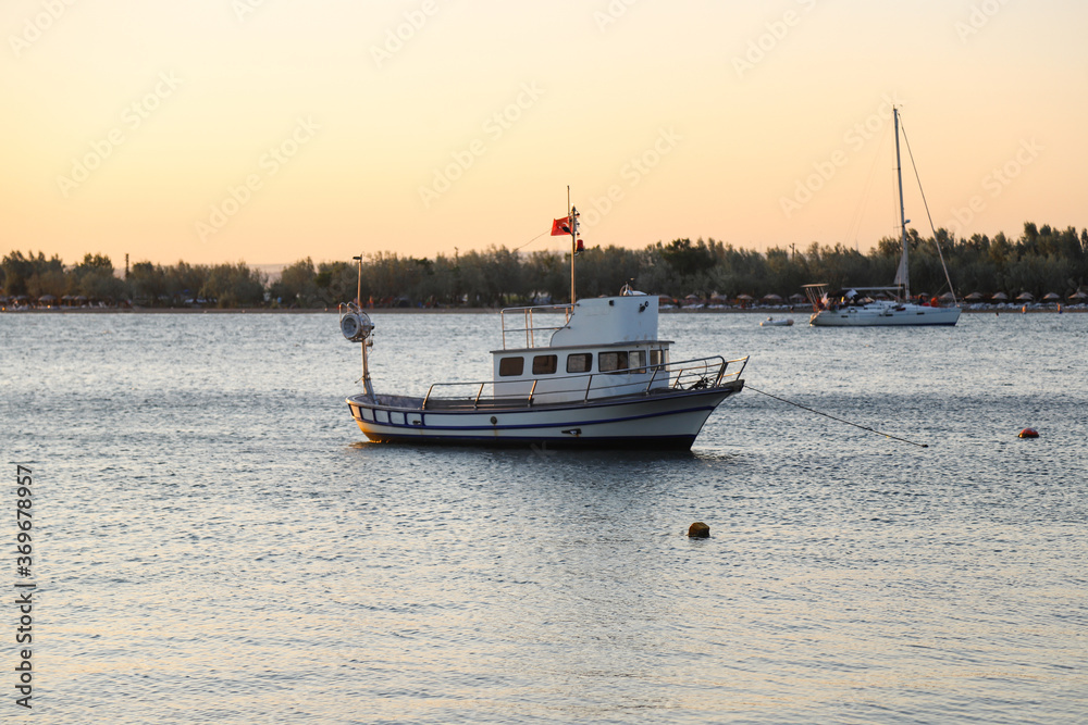 Fishing ship at sunset. Traditional fishing boat