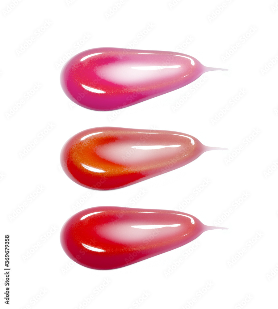 Different lip glosses isolated on white
