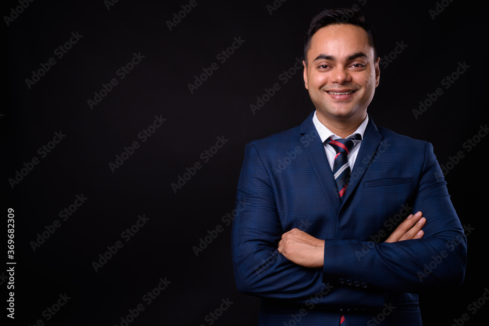Portrait of happy young handsome Indian businessman in suit Portrait of happy young handsome Indian businessman in suit