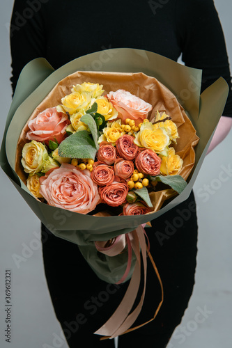 Fototapeta Naklejka Na Ścianę i Meble -  Bouquet of flowers in pistachio-colored package