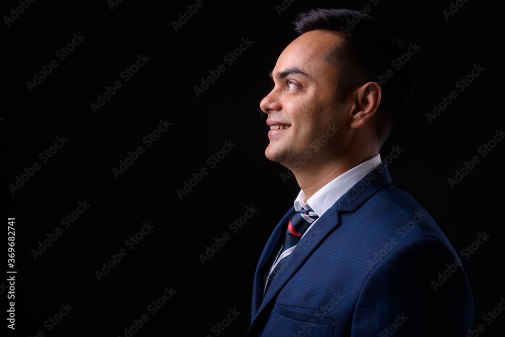 Portrait of happy young handsome Indian businessman in suit Portrait of happy young handsome Indian businessman in suit