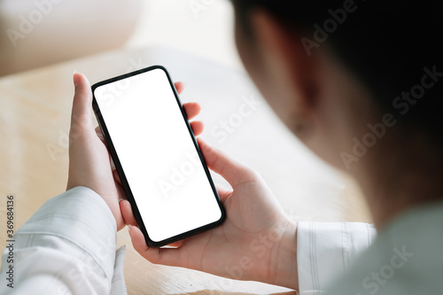 Top view Woman sitting and holding blank screen mock up mobile phone