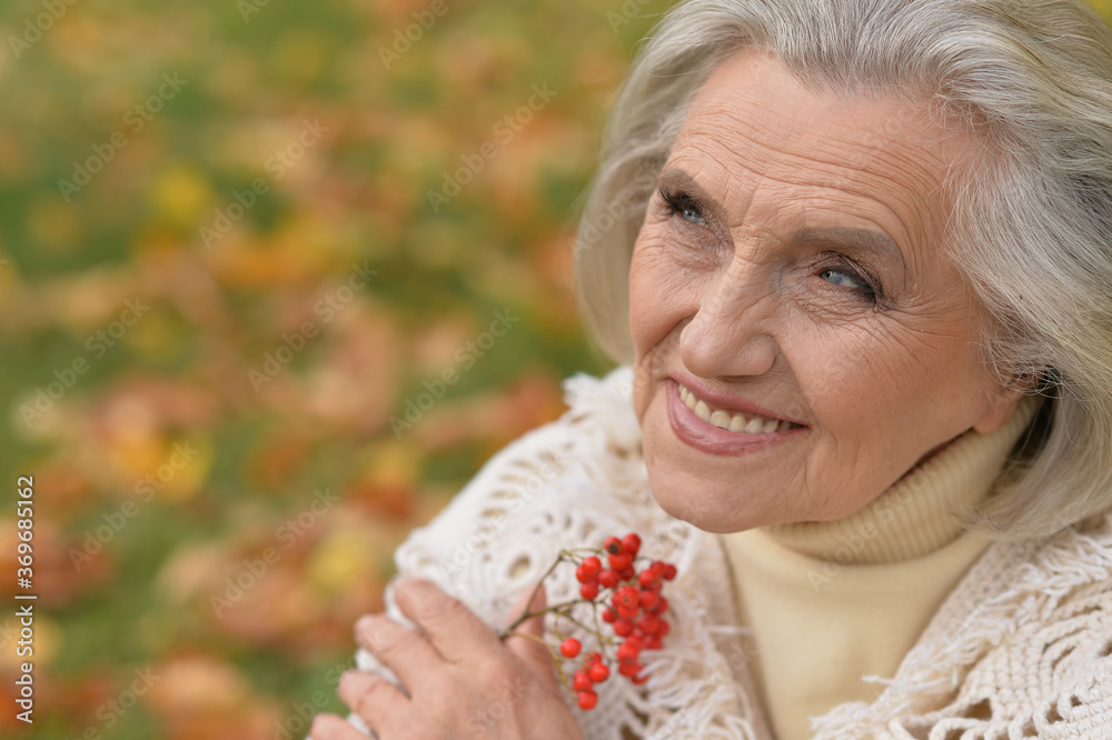 Close-up portrait of happy senior beautiful woman with berries Close-up portrait of happy senior beautiful woman with berries