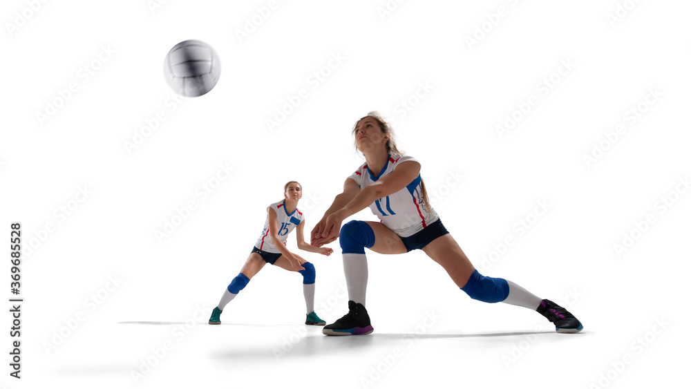 Female professional volleyball players in action on white background.