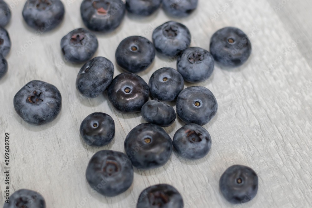 Blueberries on a white background. And also in a glass with a yellow tube. On a gray background.
Blueberries on a white background. And also in a glass with a yellow tube. On a gray background.