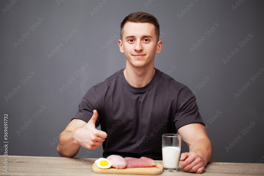 Shaped and healthy man holding a fresh meal board with meat Shaped and healthy man holding a fresh meal board with meat