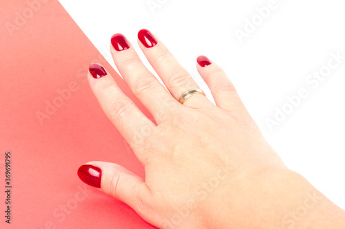 Stylish trendy female manicure. red manicure nails on red and white background