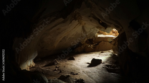 Exploring the dark Pha Thao cave near Pha Tang village in the Vang Vieng area of Laos.