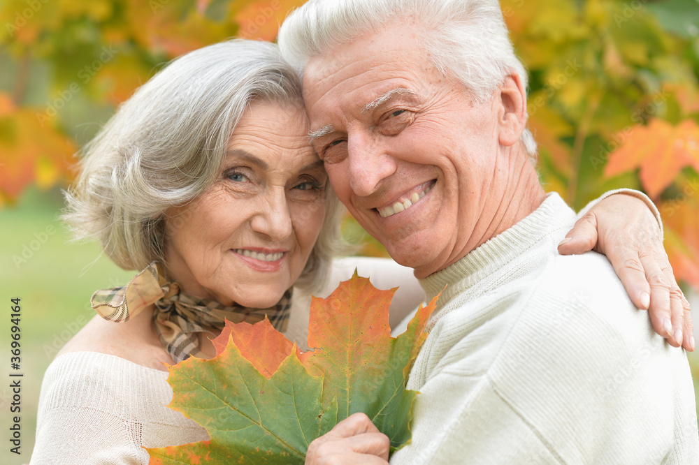 Beautiful senior couple in autumn park with leaves Beautiful senior couple in autumn park with leaves