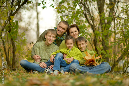 Portrait of family relaxing in autumn park