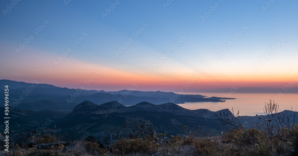 Sunset over the Gulf of Saint Florent and the sedimentary hills of Patrimonio, famous wine producing region of Corsica