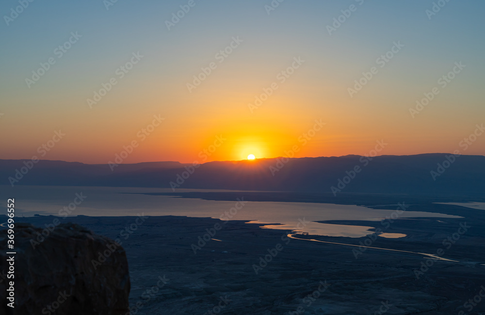 Dawn  over the mountains of Jordan and the Dead Sea. View from the territory of the ruins of the Massada fortress in Israel.