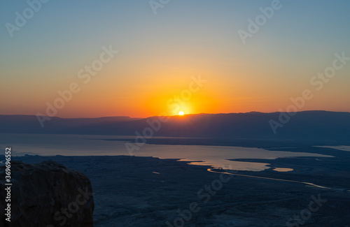 Dawn over the mountains of Jordan and the Dead Sea. View from the territory of the ruins of the Massada fortress in Israel.
