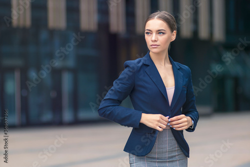 Portrait of serious beautiful businesswoman, young confident pensive girl in formal suit, jacket and skirt looking into distance with thoughtful look outdoors. Business, people concept