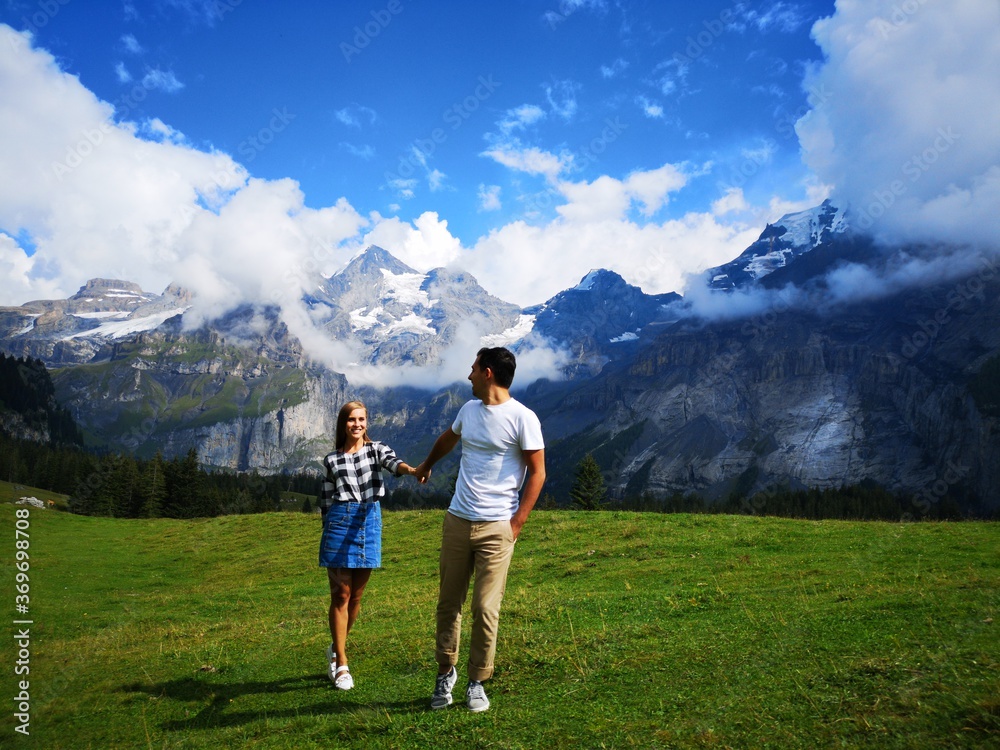 Fotografie Beautiful couple posing together with mountains in background