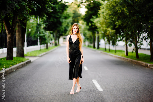 portrait beautiful girl in black dress outdoors © Pavel