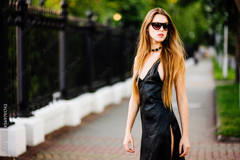 portrait beautiful girl in black dress outdoors, woman in glasses