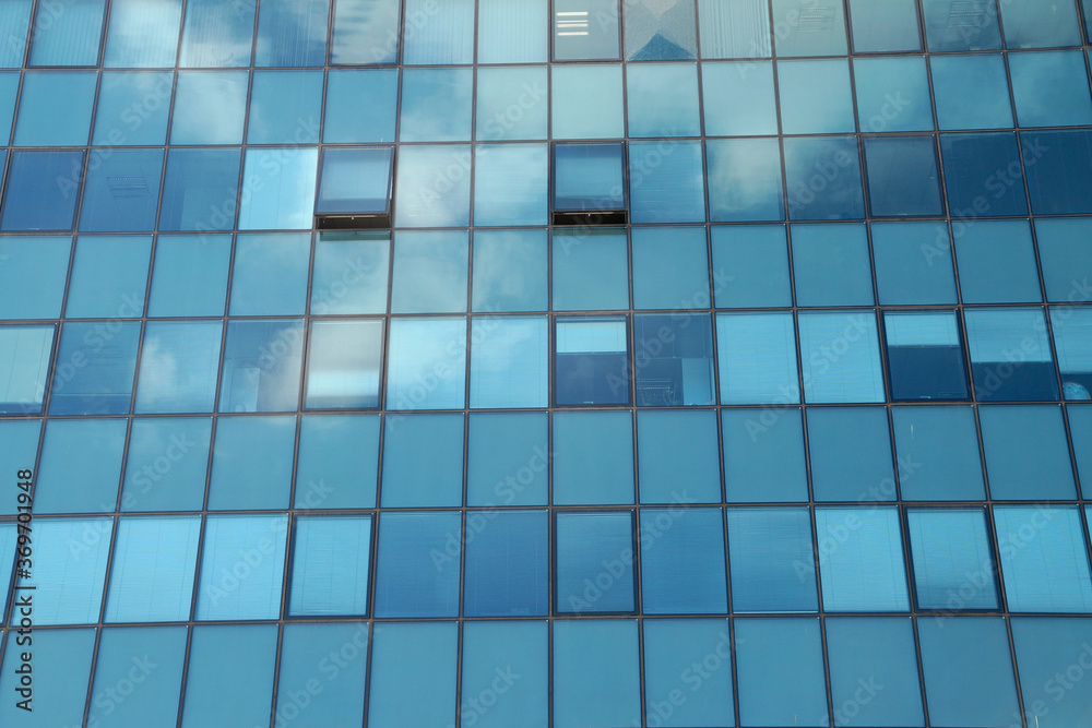 Clouds reflected in the glass facade of a skyscraper Clouds reflected in the glass facade of a skyscraper