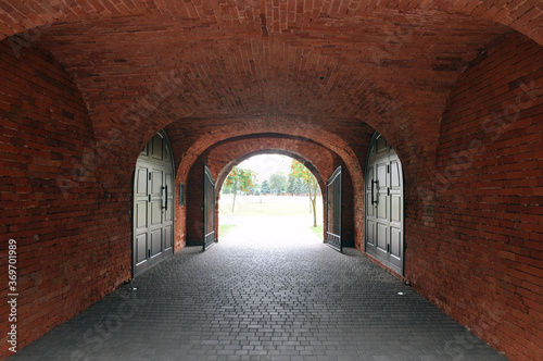 Narrow passage with a dark tunnel in the fortifications of the Brest Fortress.