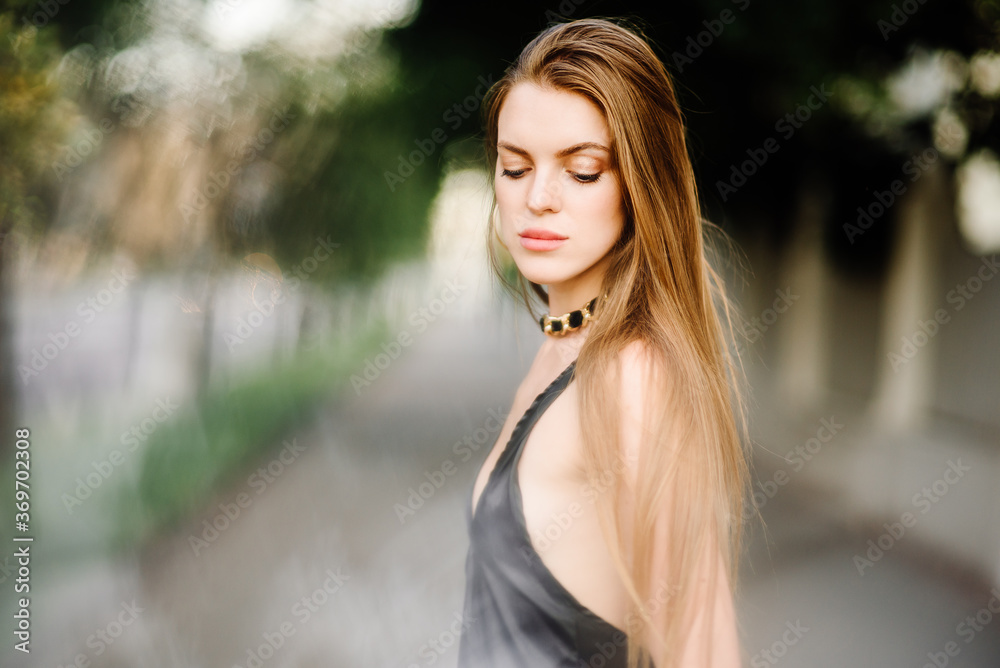 portrait of beautiful young girl in black dress outdoors, attractive woman with long hair portrait of beautiful young girl in black dress outdoors, attractive woman with long hair