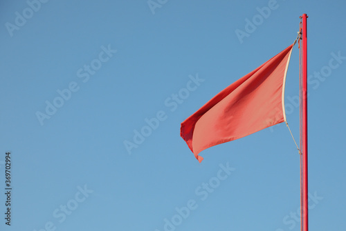 red flag indicating a dangerous situation on the background of t