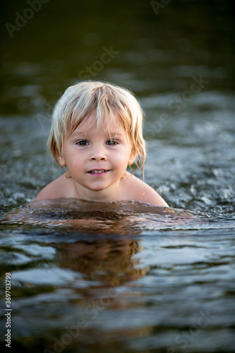 Beautiful portrait of child in lake  kid playing