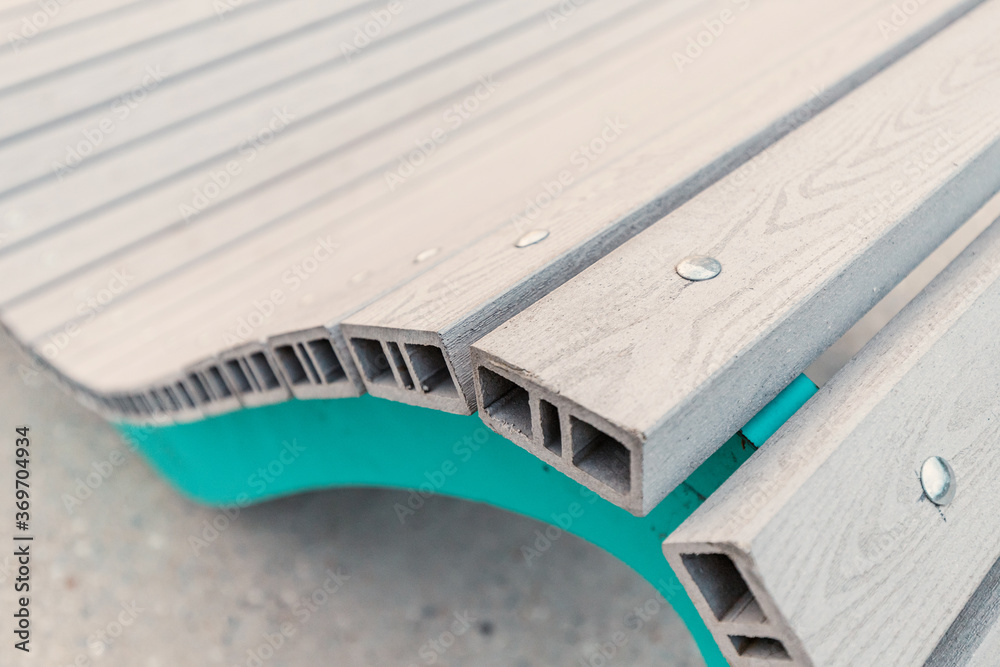 Obraz premium Close-up and detailed view of the Assembly of accessories for benches and sun beds on the city embankment