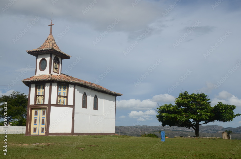 Mother Church in Milho Verde/MG with green grass and blue sky at sunny day