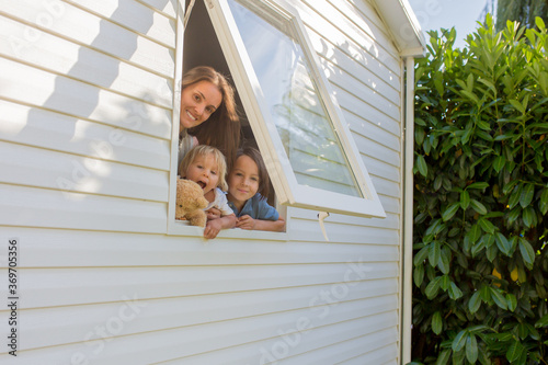 Mother and child, looking through window of mobile home