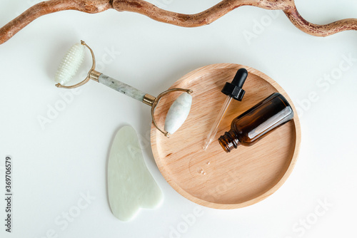 Facial massage roller and guache scraper on wood background. Advertising Beauty salon, face massage. Place for the text. Stock photography photo