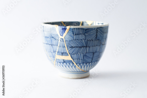 Japanese kintsugi ceramic teapot restored with real gold. Antique pottery kintsukuroi.