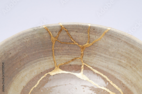 Japanese kintsugi ceramic chawan bowl restored with real gold. Antique pottery kintsukuroi.