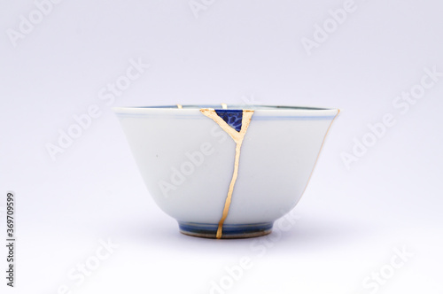 Japanese kintsugi ceramic teapot restored with real gold. Antique pottery kintsukuroi.