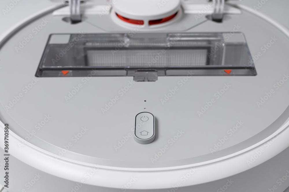 Fototapeta premium Modern robot vacuum cleaner on gray background flat lay. New technologies, quick house cleaning, automatic robot assistant. Free time to relax. Future technology, smart appliance for cleaning house