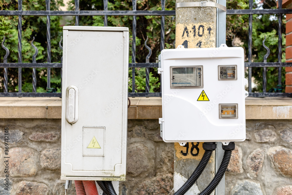 electrical panel with a warning sign on the street pole electrical panel with a warning sign on the street pole