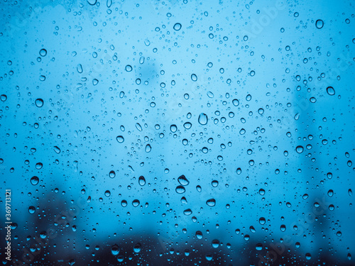 Image of water droplets on a clear glass surface during heavy rain