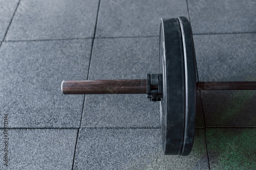 Close up view of barbell that lying down on the ground in modern gym