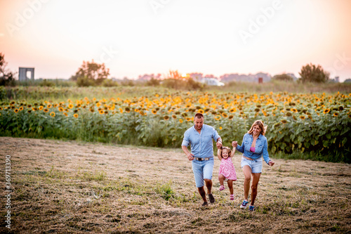 Happy family with a girl having fun in the nature