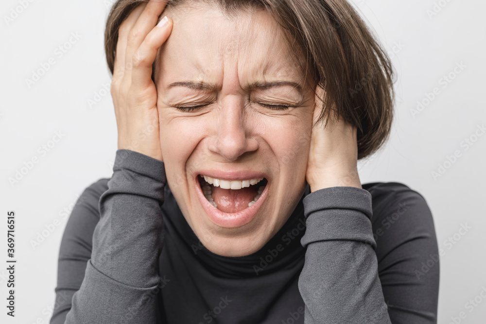The woman is screaming and crying emotionally. The woman is screaming and crying emotionally.