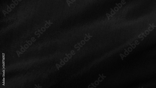 beautiful black textile cloth background. detail of wavy black opaque fabric background.