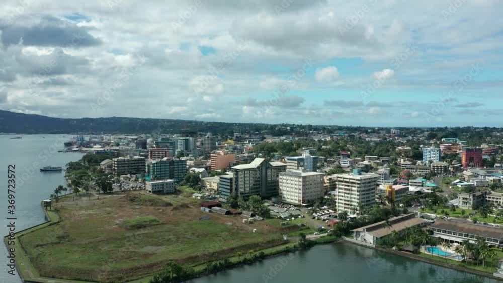 Hotels and resorts on coast of capital Suva in Fiji, aerial shot, pan right