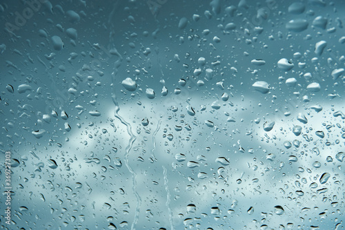 Water drops on glass, during the day.