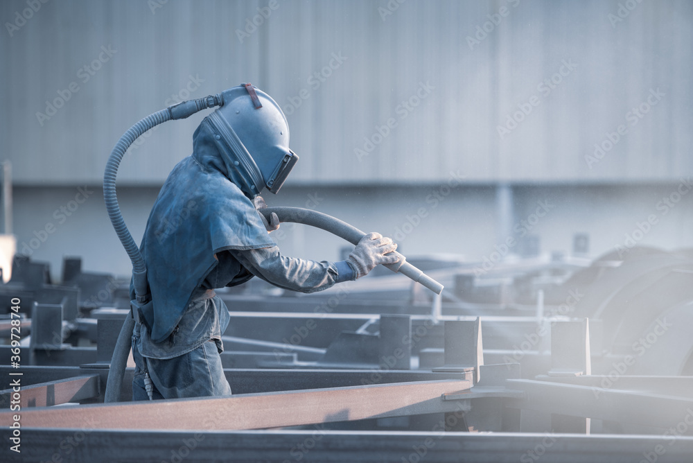 Sand blasting process, Industial worker using sand blasting process