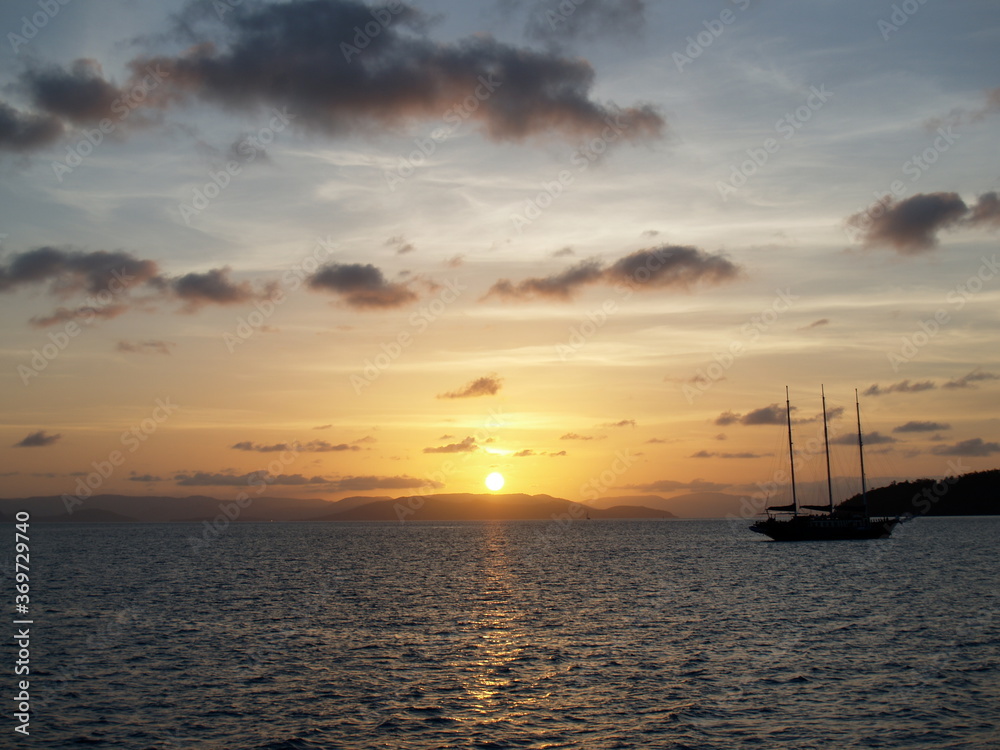 Sailing during a sunset around Whitsunday Islands in Australia