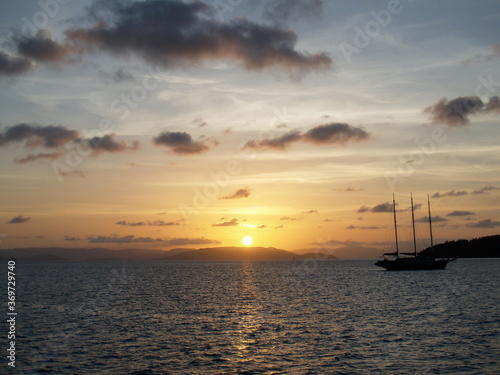 Sailing during a sunset around Whitsunday Islands in Australia © KashDesign