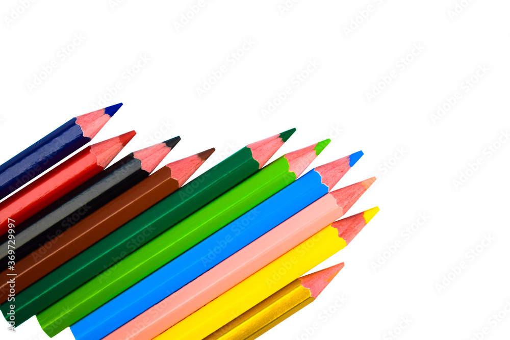 Fototapeta premium Many different colored wood pencil crayons scattered on a white background