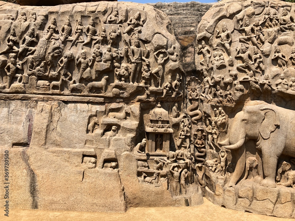 Fototapeta premium Bas relief sculptures on the wall of the rock cut cave temples in Mahabalipuram, Tamil nadu.